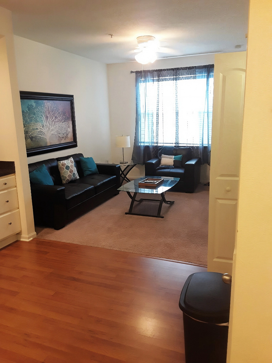 Furnished dining area with table and chairs beside the kitchen in a two bedroom Simpsonville apartment