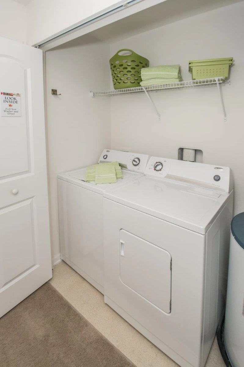 Washer and dryer in the in unit laundry closet of a furnished apartment